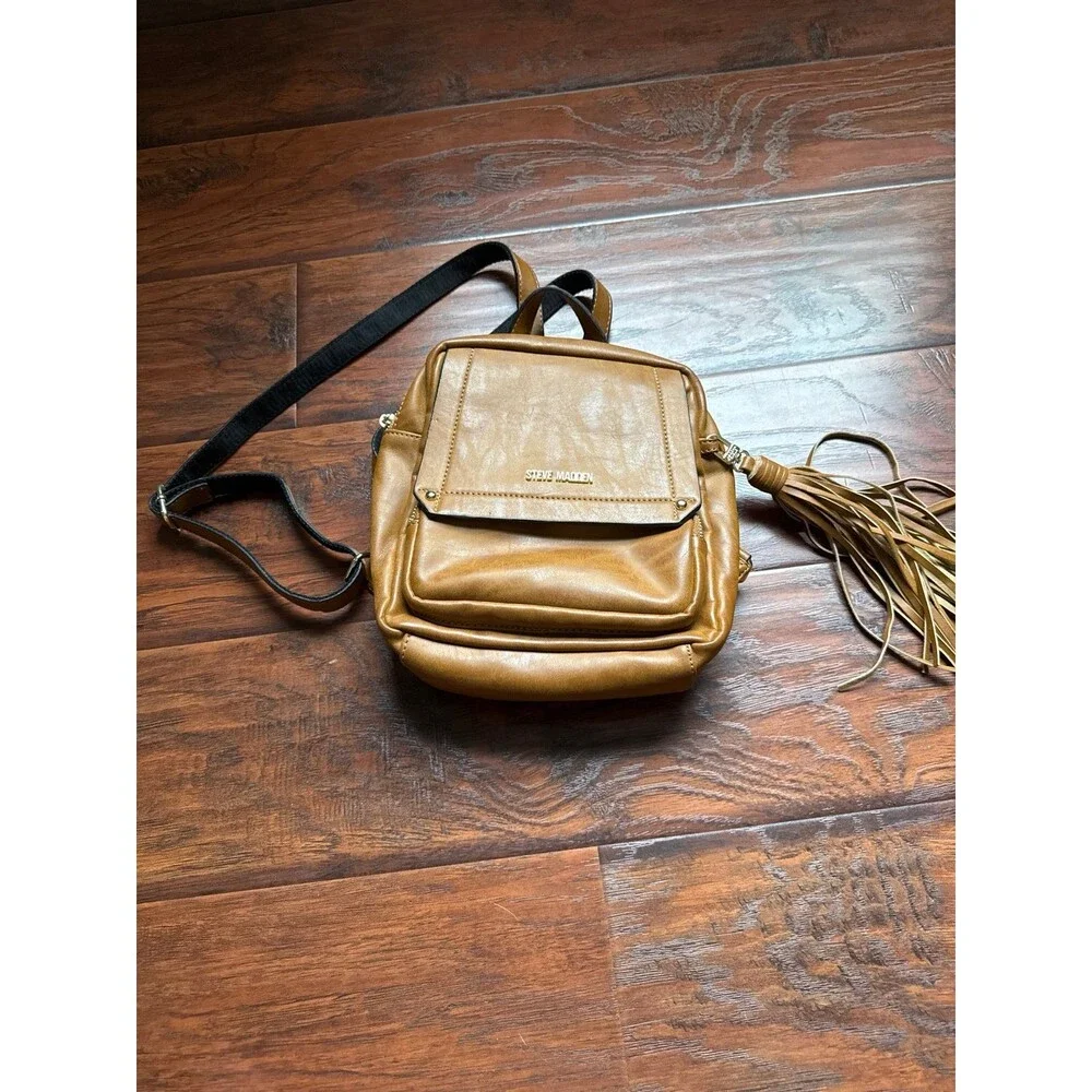 Steve Madden camel-colored Tampa backpack featuring a tassel detail